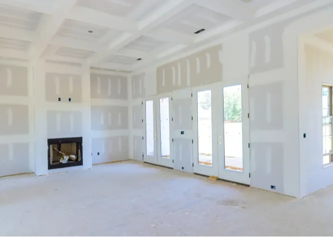 Unfinished living room with drywall and fireplace