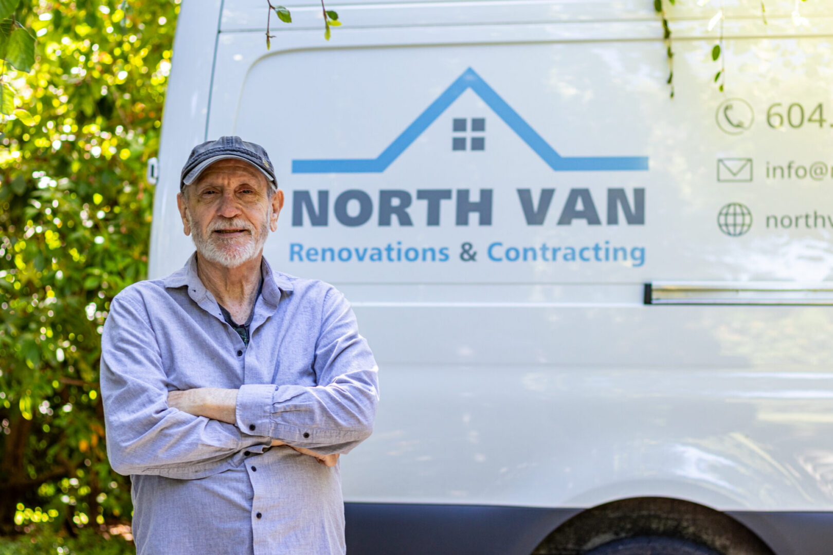 Contractor standing by renovation company van